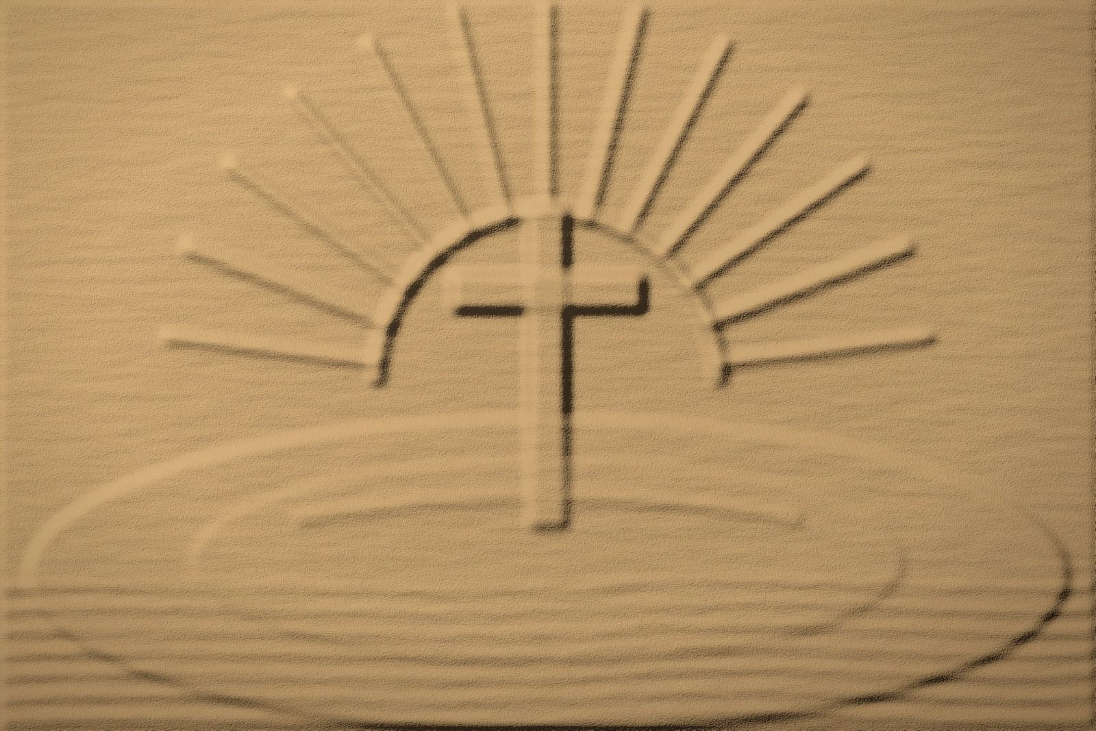 Warm sand relief of a cross rising in front of a half-sun with carved rays, over a broad mound with rippled sand in the foreground