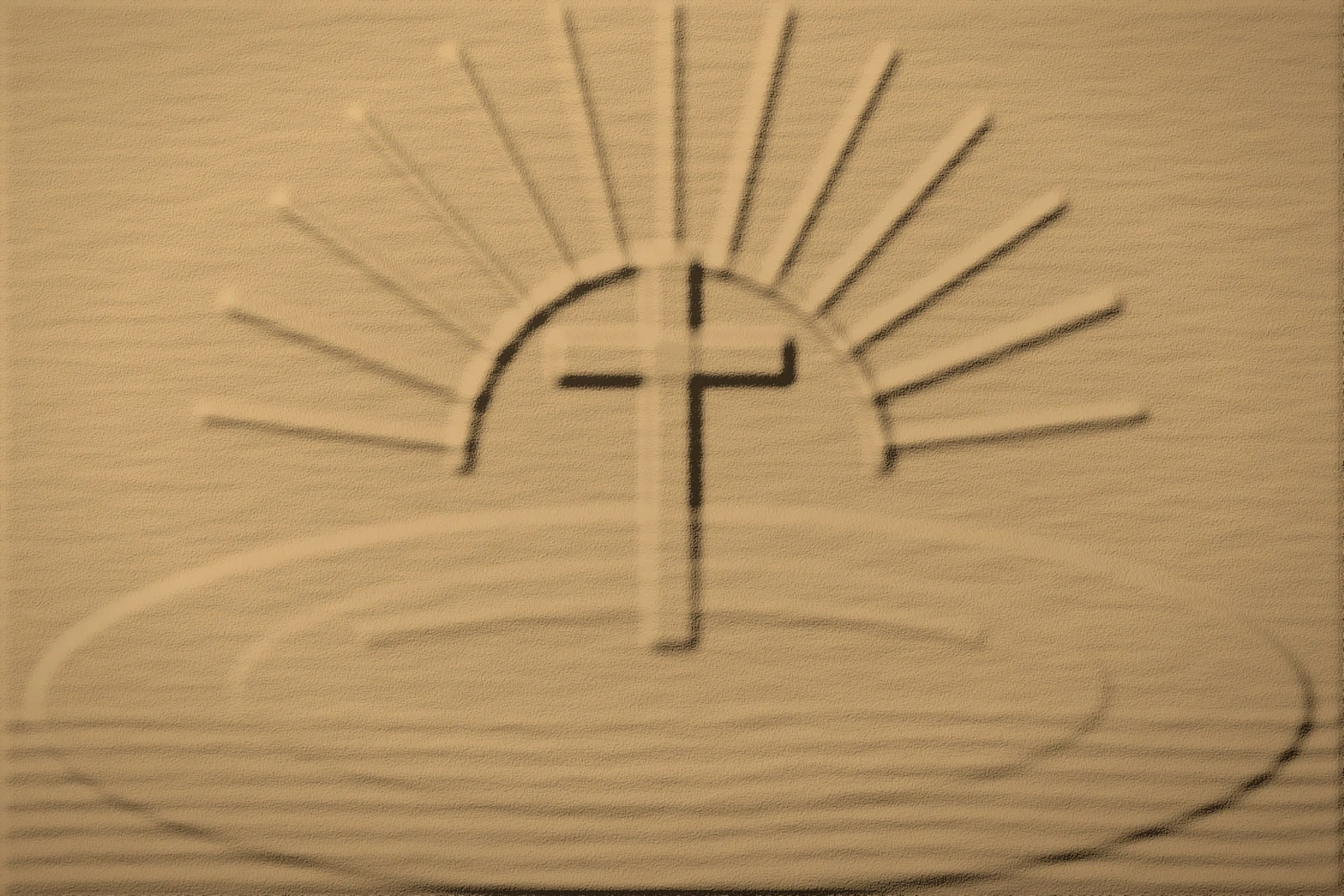 Warm sand relief of a cross rising in front of a half-sun with carved rays, over a broad mound with rippled sand in the foreground